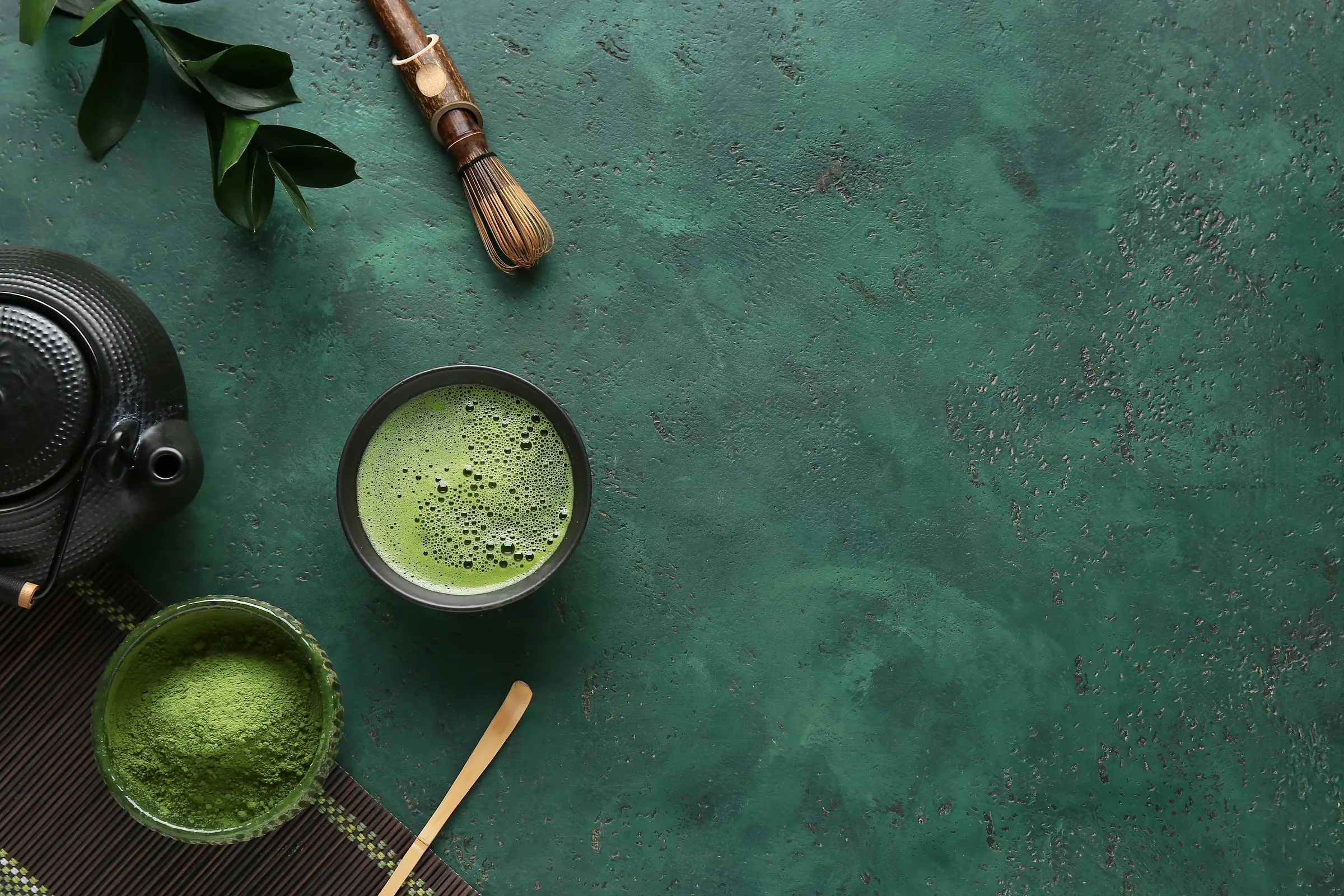 Matcha powder, a bowl and a bamboo whisk